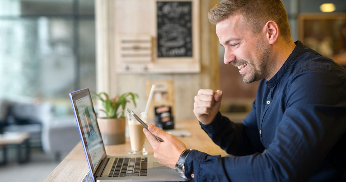 happy-freelancer-with-tablet-laptop-computer-coffee-shop